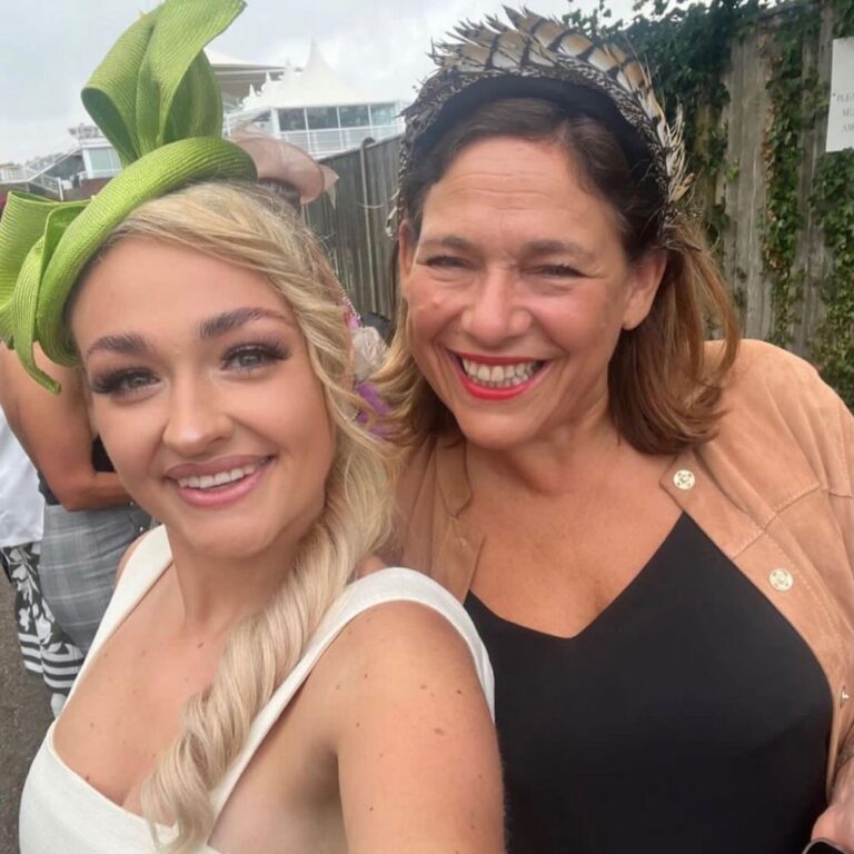 2 ladies wearing hats to the races